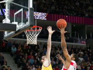 Deux joueurs de basketball dans un duel sur une tentative de lay-up
